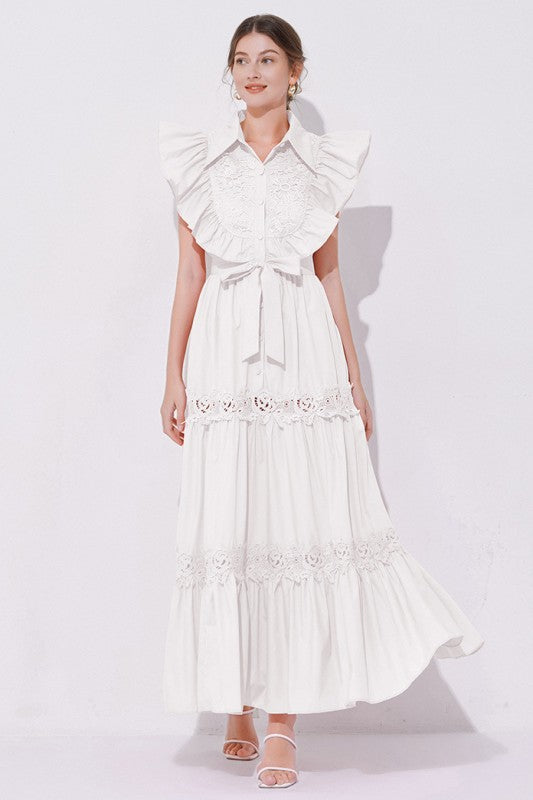  A white, midi-length piece with a tiered, ruffled silhouette and short puff sleeves, featuring delicate lace detailing for a romantic, bohemian look.