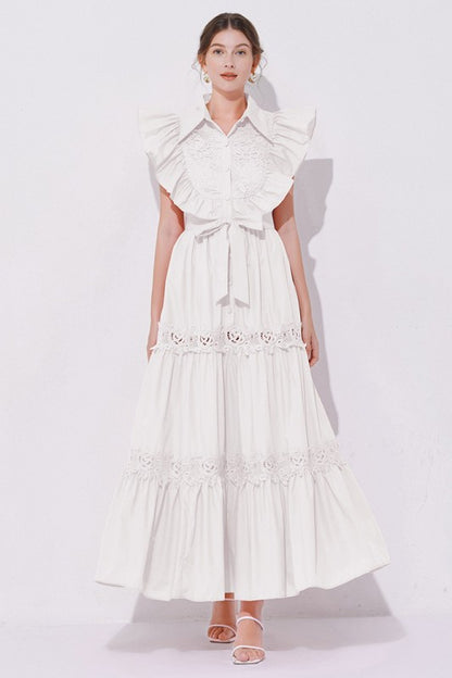 A white, midi-length piece with a tiered, ruffled silhouette and short puff sleeves, featuring delicate lace detailing for a romantic, bohemian look.