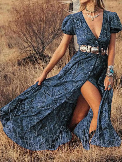 Woman wearing a black and white striped short-sleeve shift mini dress with ruffled sleeves, standing by a wooden door holding a straw hat.
