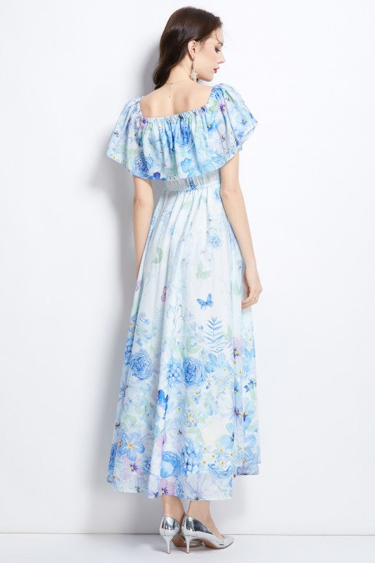 A light blue floral maxi dress with off-shoulder sleeves and a flowing, airy skirt.