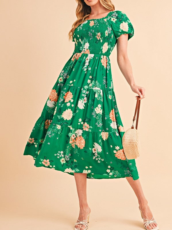 Women's smocked floral midi dress with tiered skirt and puff sleeves, perfect for summer