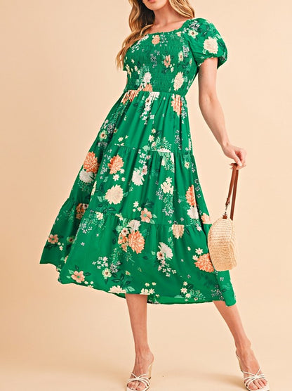 Women's smocked floral midi dress with tiered skirt and puff sleeves, perfect for summer