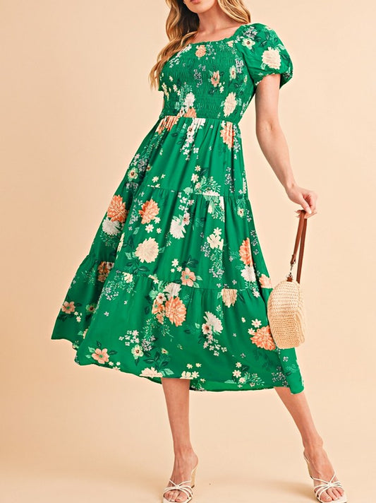 Women's smocked floral midi dress with tiered skirt and puff sleeves, perfect for summer