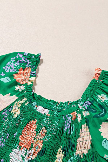 Women's smocked floral midi dress with tiered skirt and puff sleeves, perfect for summer.