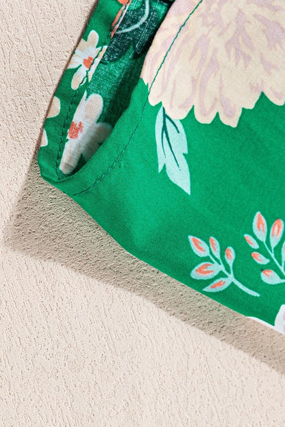 Women's smocked floral midi dress with tiered skirt and puff sleeves, perfect for summer.