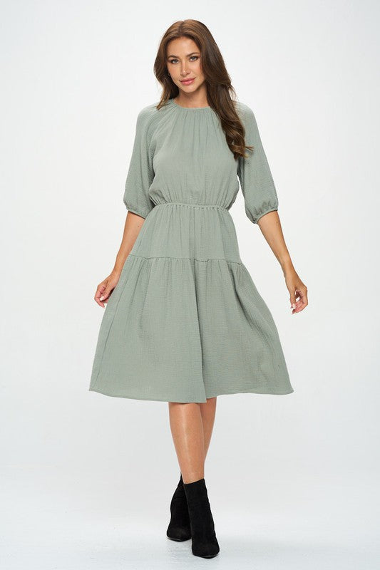 Women's textured gauze tiered midi dress with elastic waist and 3/4 puff sleeves.