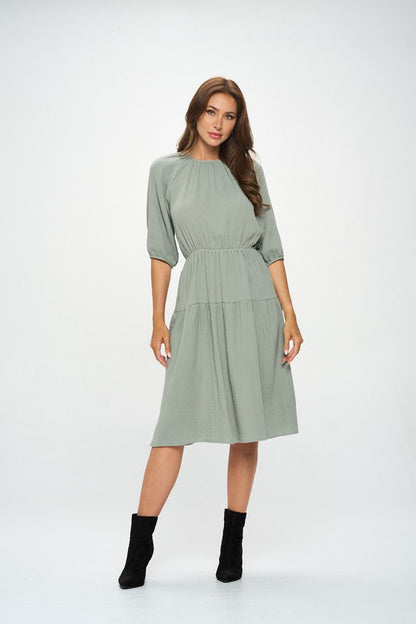 Women's textured gauze tiered midi dress with elastic waist and 3/4 puff sleeves.