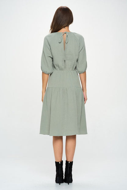 Women's textured gauze tiered midi dress with elastic waist and 3/4 puff sleeves.