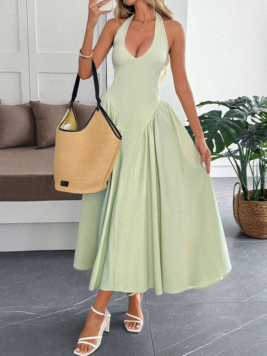 Women's halter neck dress with deep V-neckline and dramatic paneled flare skirt.