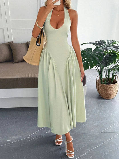 Women's halter neck dress with deep V-neckline and dramatic paneled flare skirt.