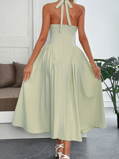 Women's halter neck dress with deep V-neckline and dramatic paneled flare skirt.