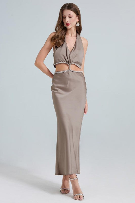 A sleek, taupe maxi dress with a twisted front knot and cut-out detail at the waist, fitted silhouette and a subtle high slit.