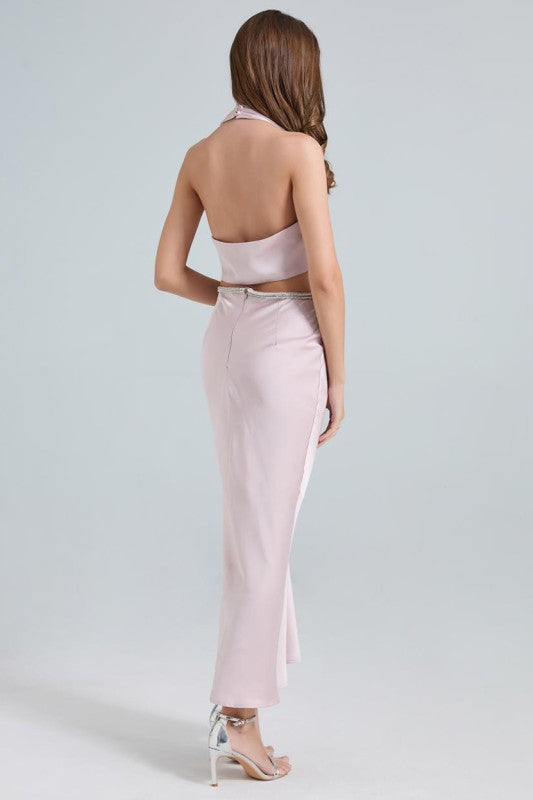 A sleek, taupe-colored satin-style gown with a plunging neckline, a twisted front detail, and a fitted silhouette that falls to a midi-length hem.