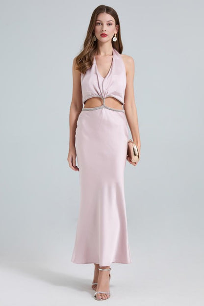 A sleek, taupe maxi dress with a twisted front knot and cut-out detail at the waist, fitted silhouette and a subtle high slit.