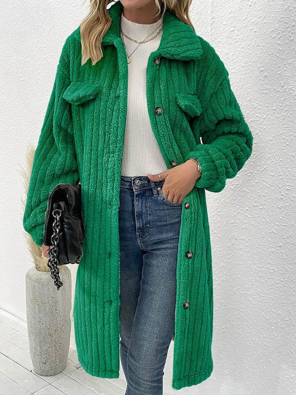 Person wearing a green knitted coat with a white background