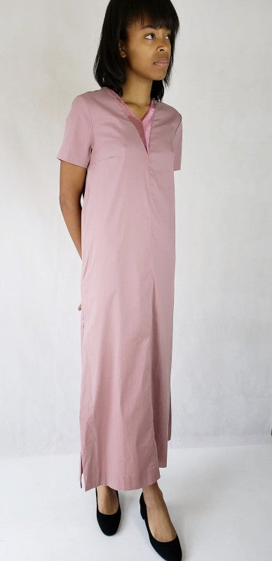 This maxi dress features dramatic long side slits and a flattering deep V-neck, accented by practical pockets for chic, effortless style.