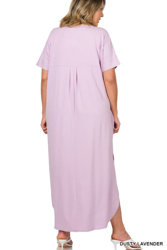 A loose, knee- to ankle-length royal pink dress with short sleeves and a side slit.