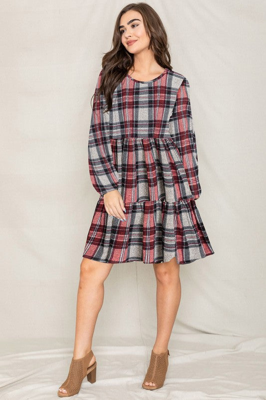 Women's plaid flannel mini dress with tiered skirt, babydoll style, and long balloon sleeves.
