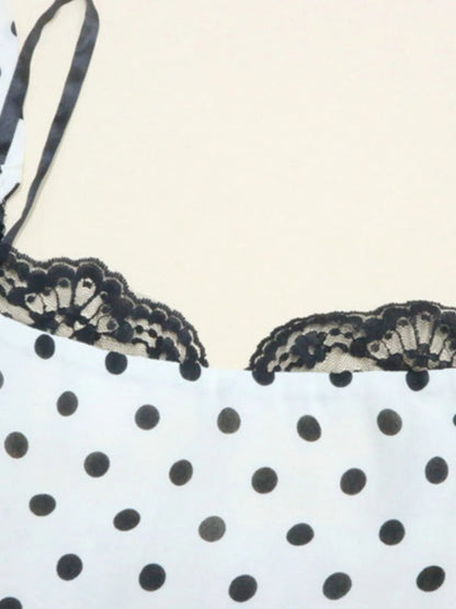 A white, polka-dotted, sleeveless maxi with a fitted bodice and a flared, ruffled hem that reaches the ankles