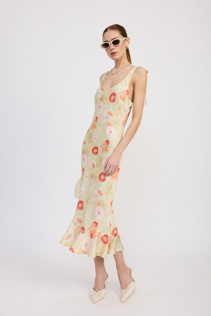Women's floral print slip dress with adjustable tie shoulder straps and a subtle mermaid hem.