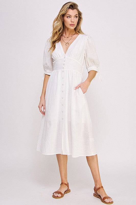 Women's button-front midi dress with V-neck, shirred waist, and 3/4 puff sleeves.