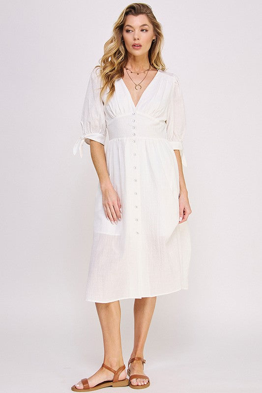 Women's button-front midi dress with V-neck, shirred waist, and 3/4 puff sleeves.