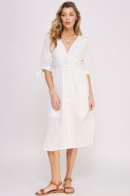 Women's button-front midi dress with V-neck, shirred waist, and 3/4 puff sleeves.