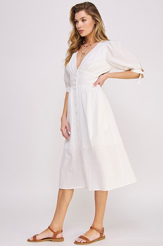 Women's button-front midi dress with V-neck, shirred waist, and 3/4 puff sleeves.