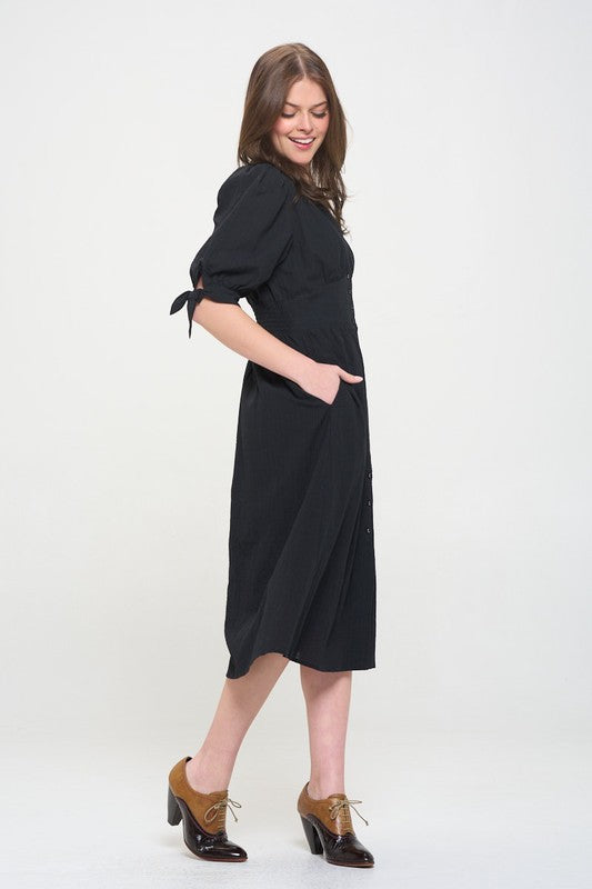 Women's button-front midi dress with V-neck, shirred waist, and 3/4 puff sleeves.