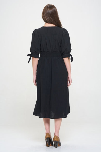 Women's button-front midi dress with V-neck, shirred waist, and 3/4 puff sleeves.
