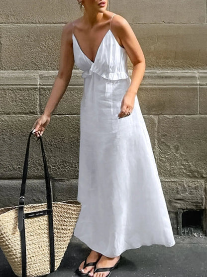 A graceful, floor-length maxi dress featuring a feminine ruffled V-neckline that adds romantic volume and movement to every step.
