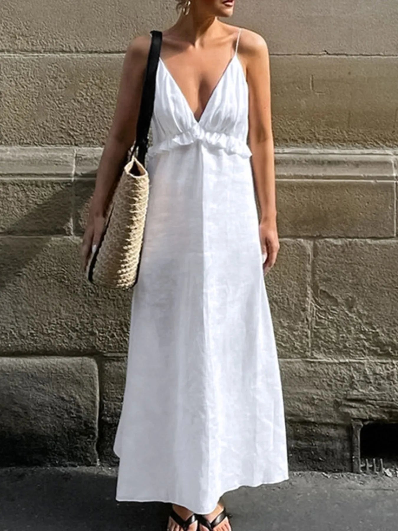 A graceful, floor-length maxi dress featuring a feminine ruffled V-neckline that adds romantic volume and movement to every step.