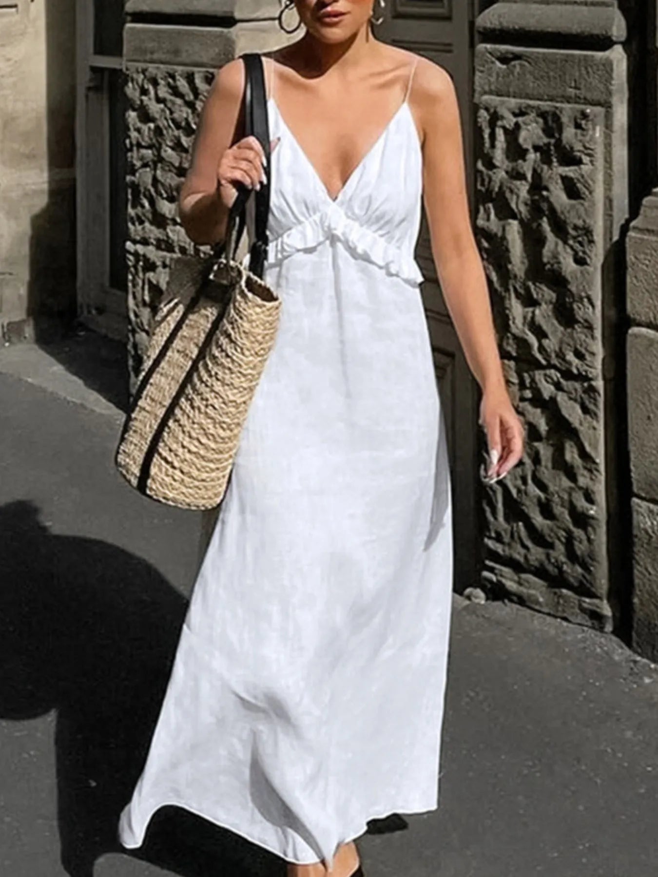 A graceful, floor-length maxi dress featuring a feminine ruffled V-neckline that adds romantic volume and movement to every step.