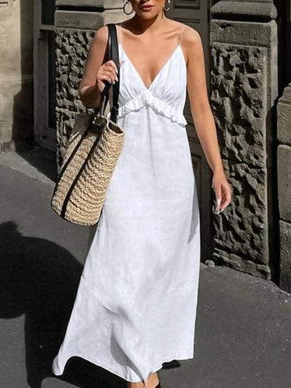 A graceful, floor-length maxi dress featuring a feminine ruffled V-neckline that adds romantic volume and movement to every step.