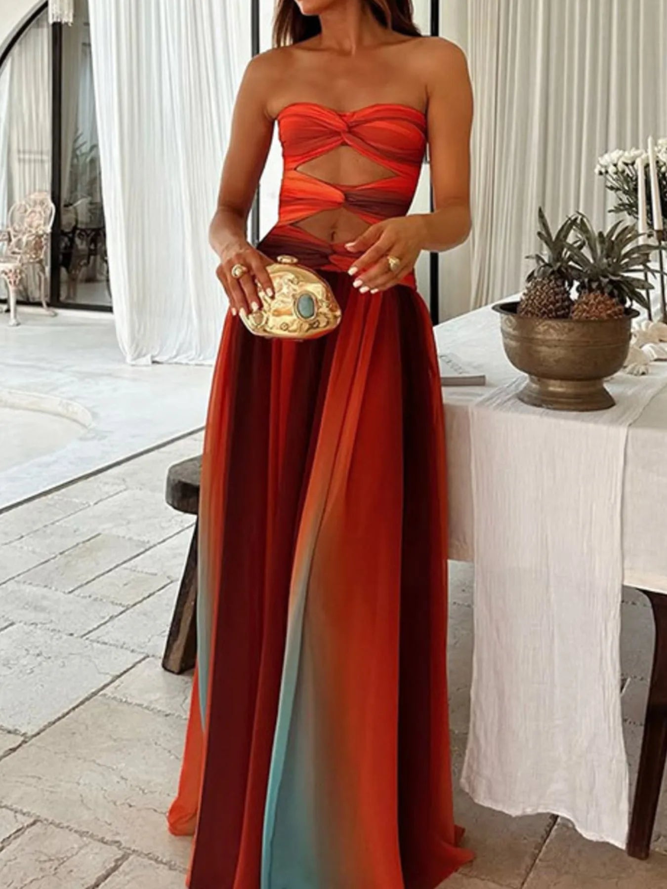 the strapless cut-out rainbow gradient maxi dress features a bold, color-shifting ombre that flows from top to hem, with sleek silhouettes and tasteful cut-outs for a daring, statement-making look