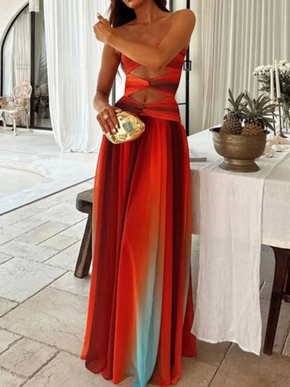 The strapless cut-out rainbow gradient maxi dress features a bold, color-shifting ombre that flows from top to hem, with sleek silhouettes and tasteful cut-outs for a daring, statement-making look.