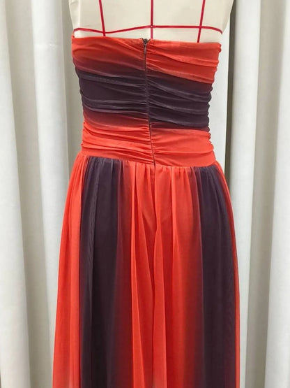 The strapless cut-out rainbow gradient maxi dress features a bold, color-shifting ombre that flows from top to hem, with sleek silhouettes and tasteful cut-outs for a daring, statement-making look.

