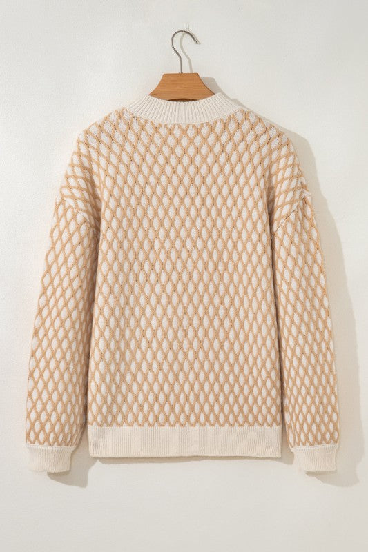Beige and cream rhombus textured sweater on a hanger, featuring a mock neck, ribbed cuffs, and hem, back view