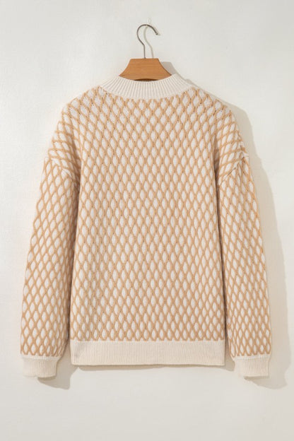 Beige and cream rhombus textured sweater on a hanger, featuring a mock neck, ribbed cuffs, and hem, back view