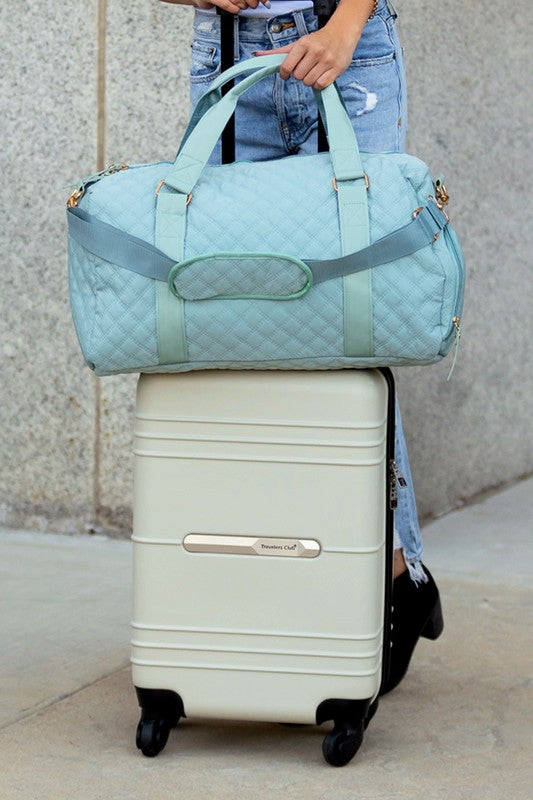 Fashionable light blue quilted weekend bag with a durable design, perfect for short trips.