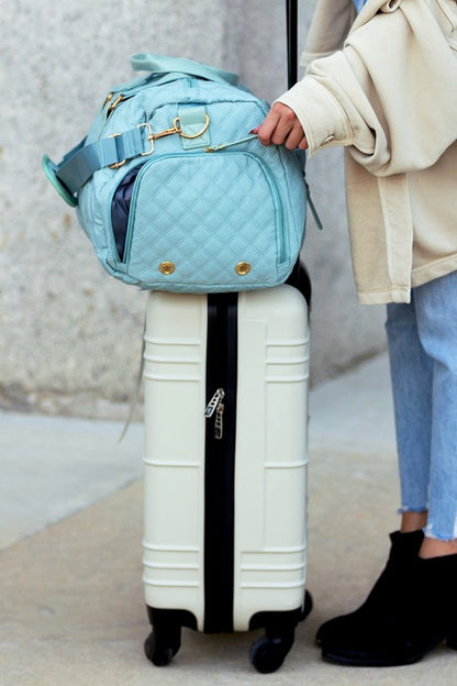 Fashionable light blue quilted weekend bag with a durable design, perfect for short trips.